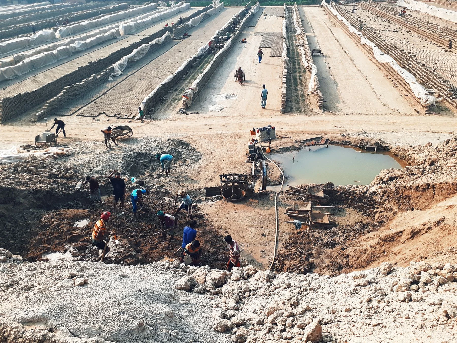 Wet excavation with water collected beside workers