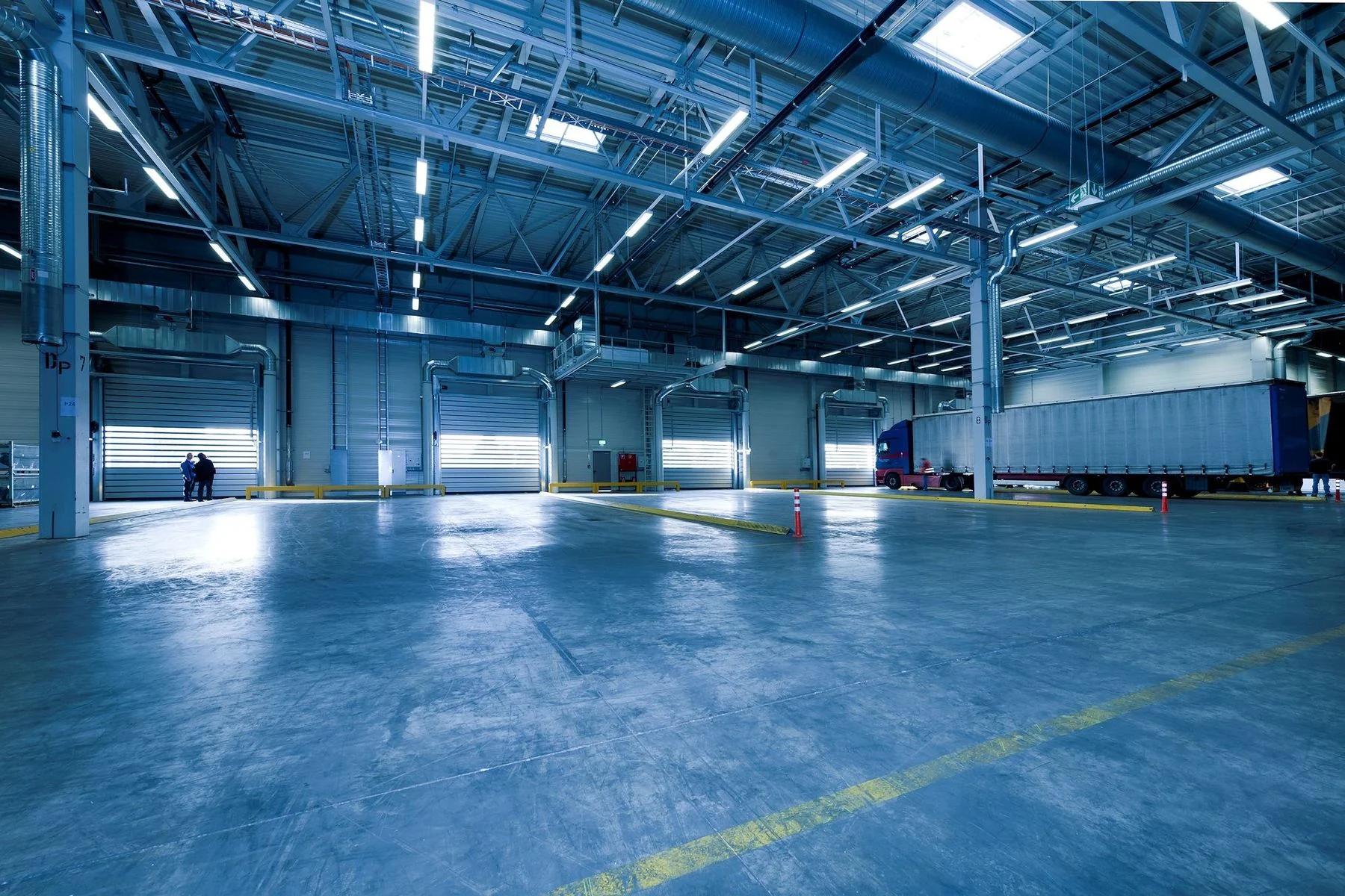 Spacious warehouse with industrial lighting and open loading docks