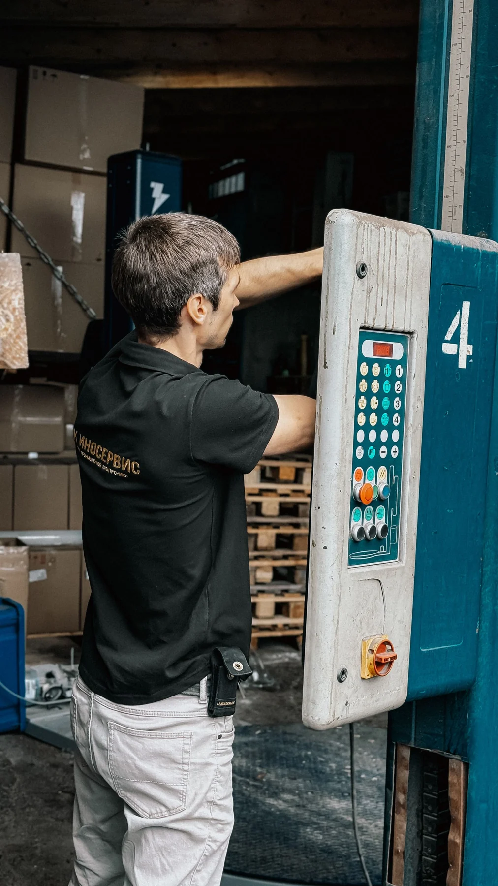 Technician at an industrial loading dock control panel
