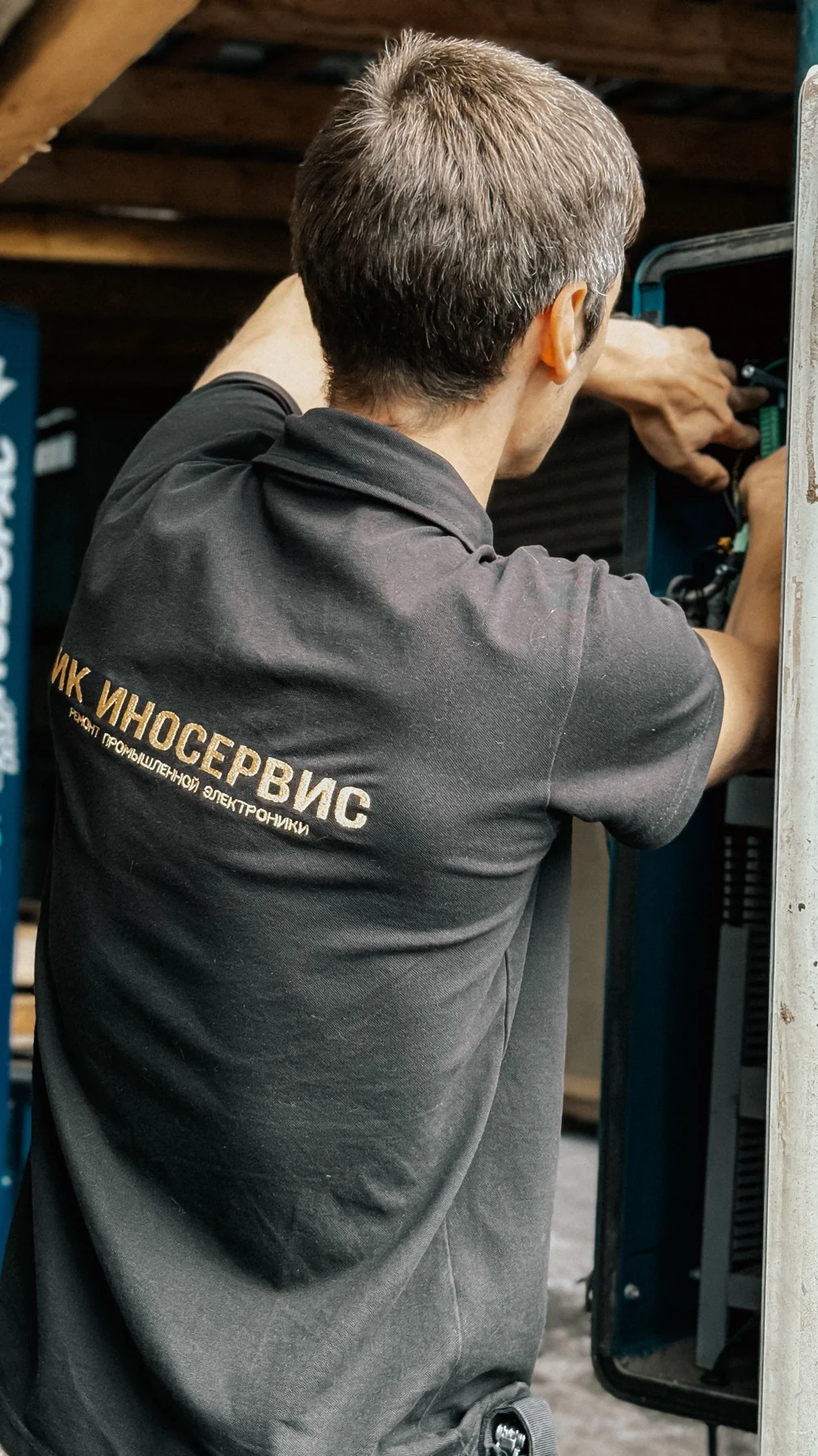 Technician working in an open industrial equipment enclosure