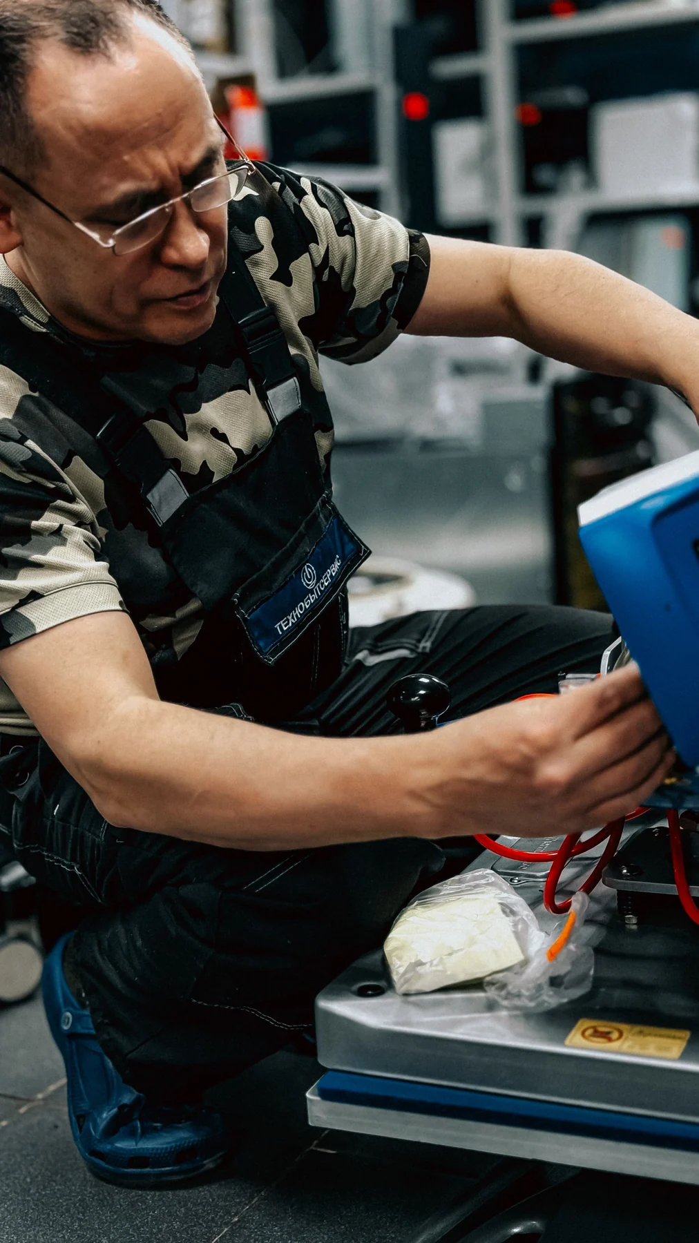 Technician working on machinery components indoors