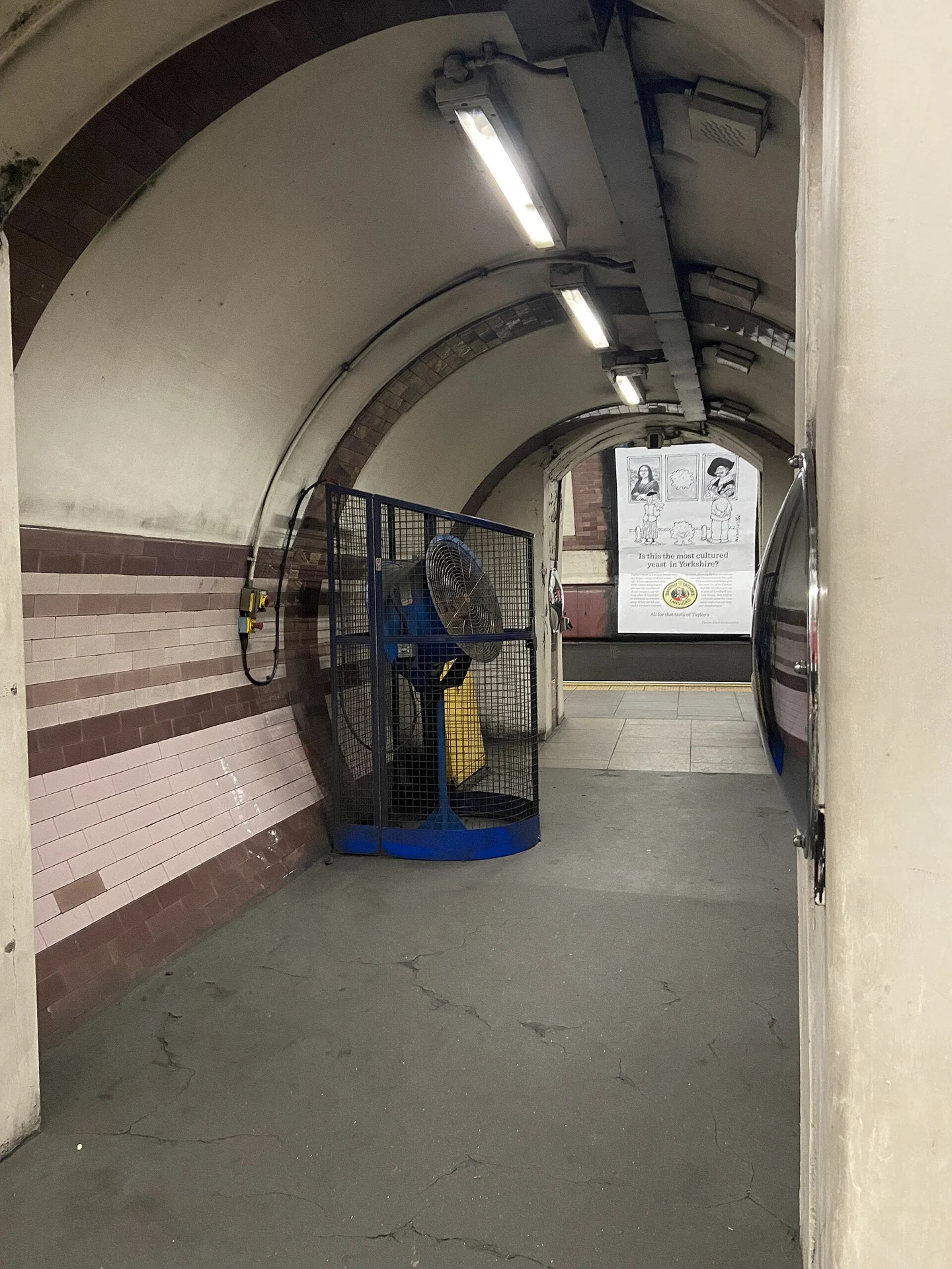 Portable industrial fan positioned in an underground passage