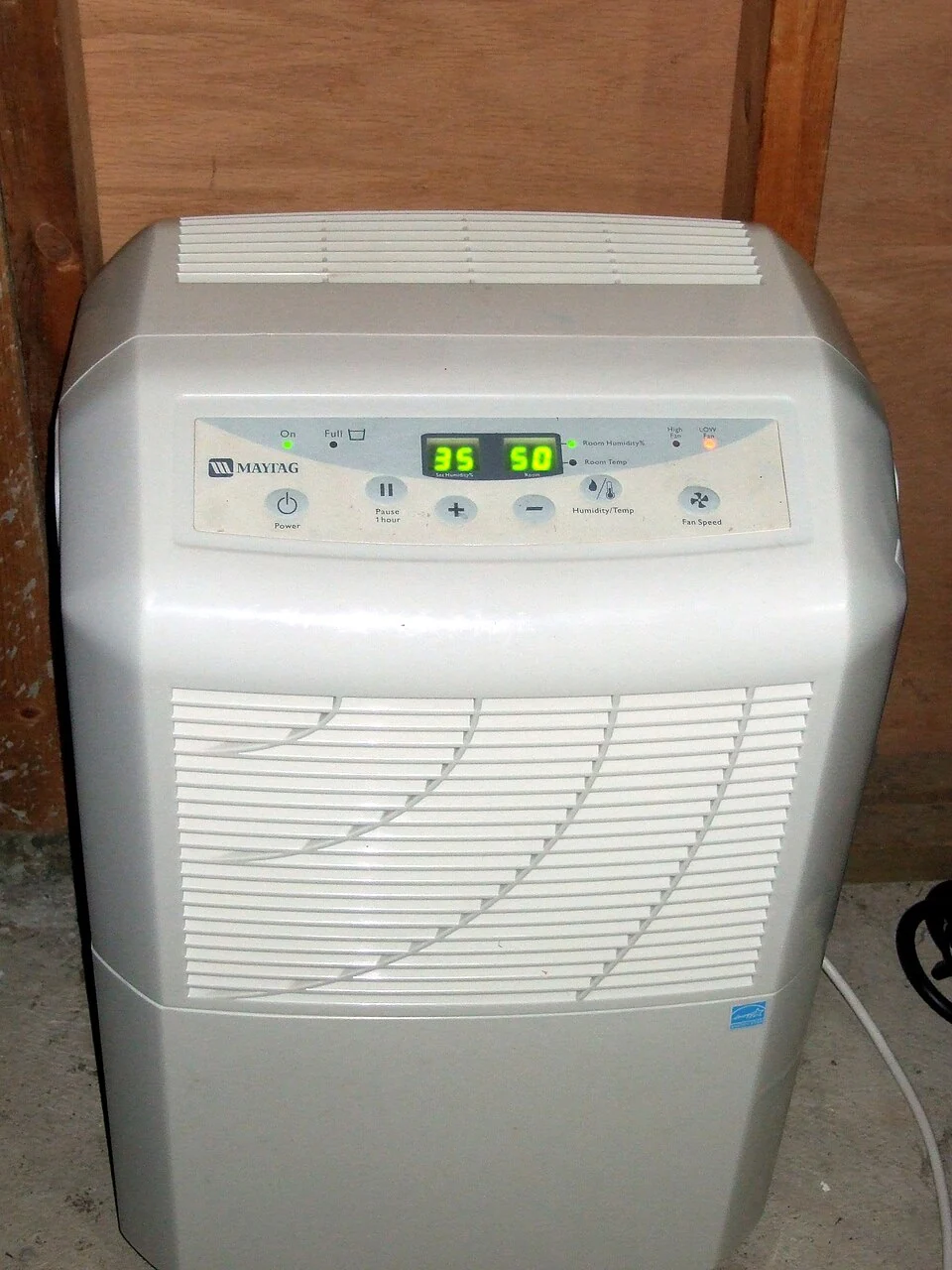 Portable dehumidifier with a front air grille