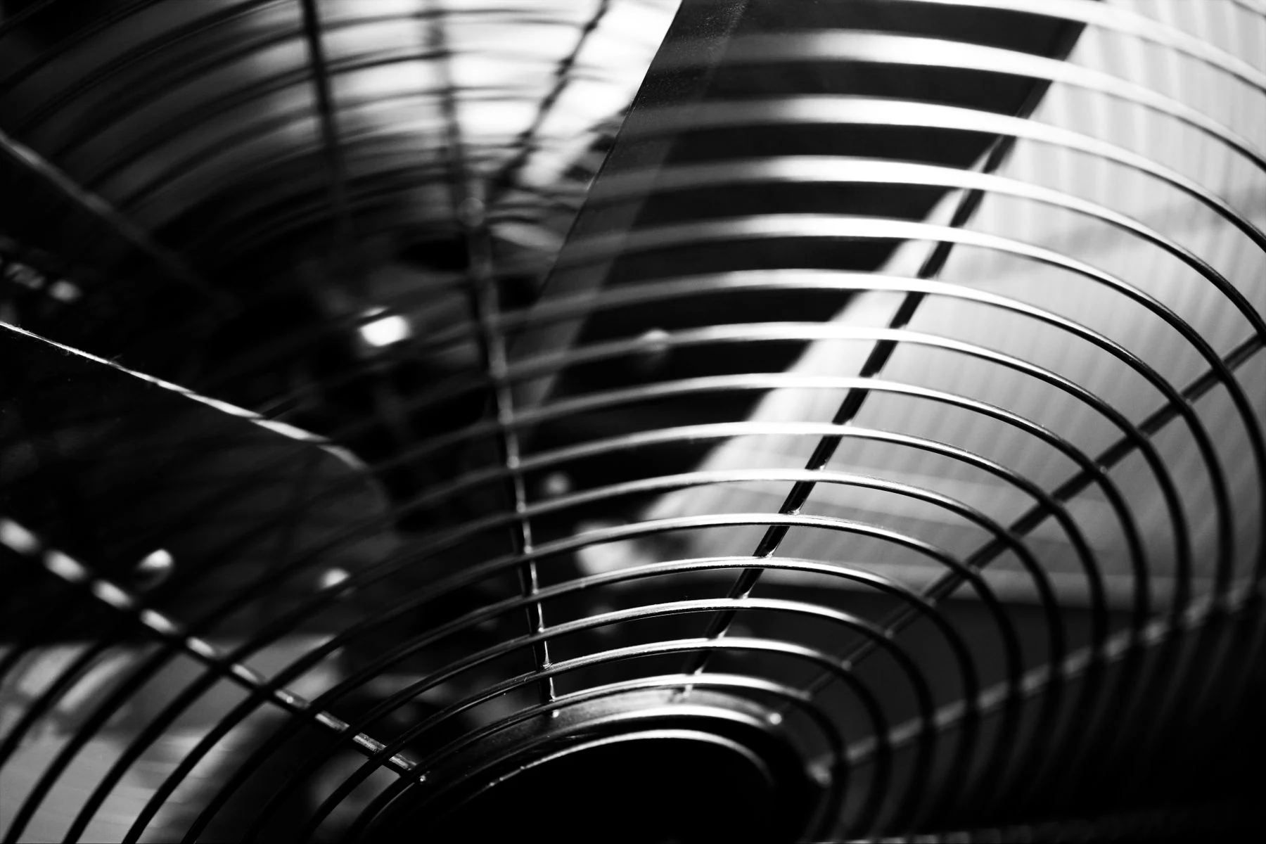 Close-up of fan blades behind a protective grille