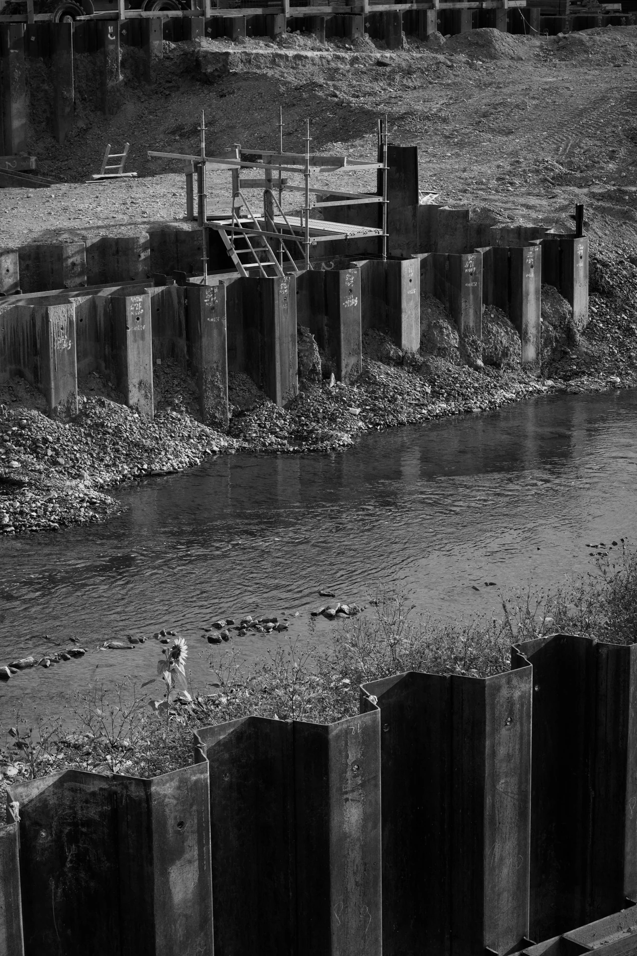 Water beside sheet-pile retaining structures at a construction site