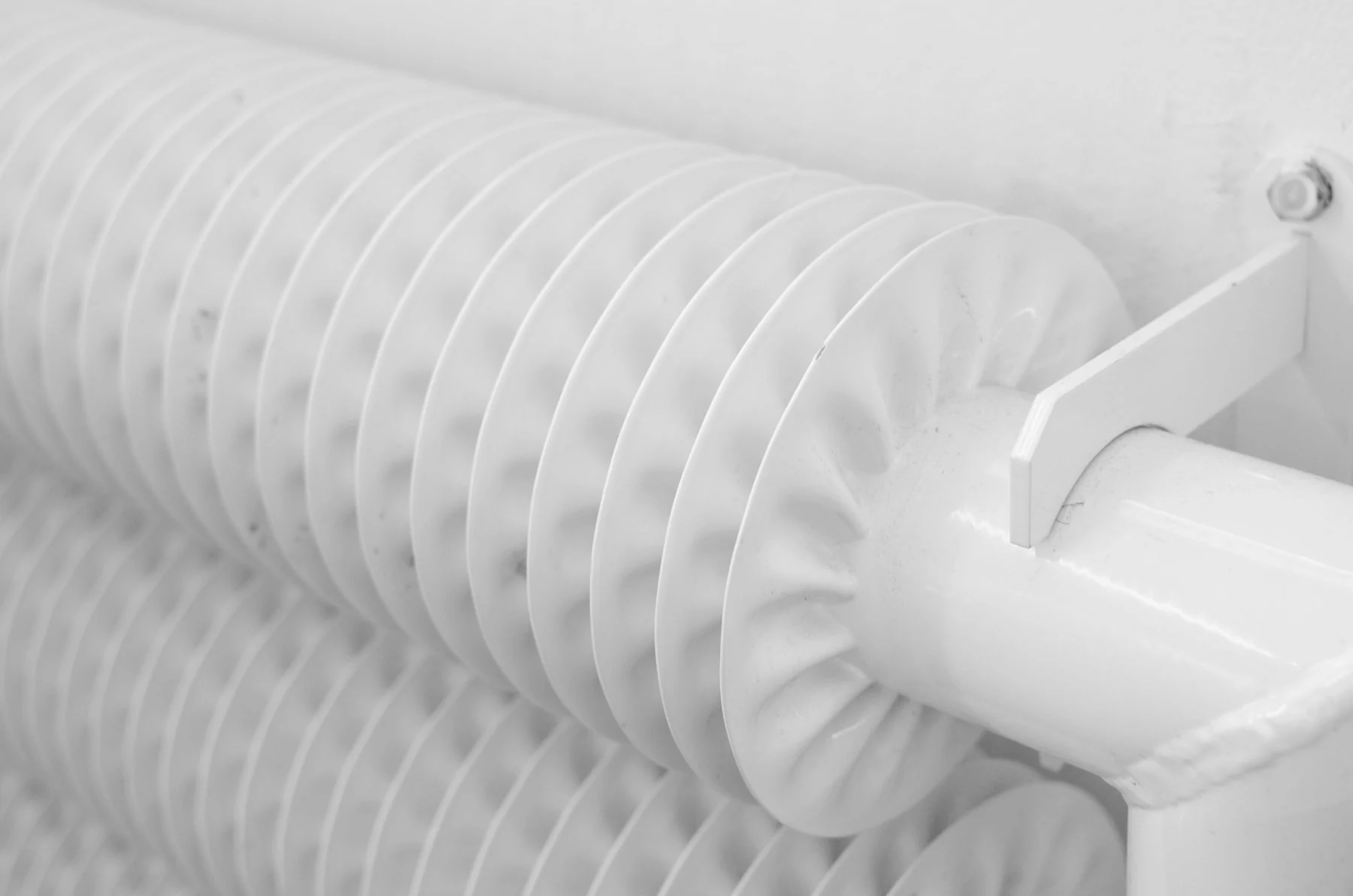 Close detail of finned heating pipework